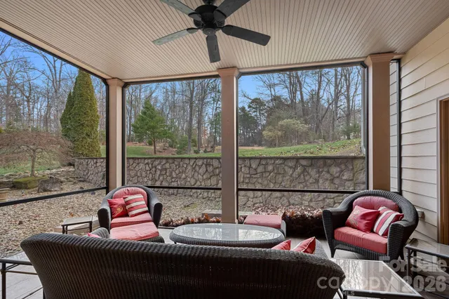 a living room with furniture and a floor to ceiling window