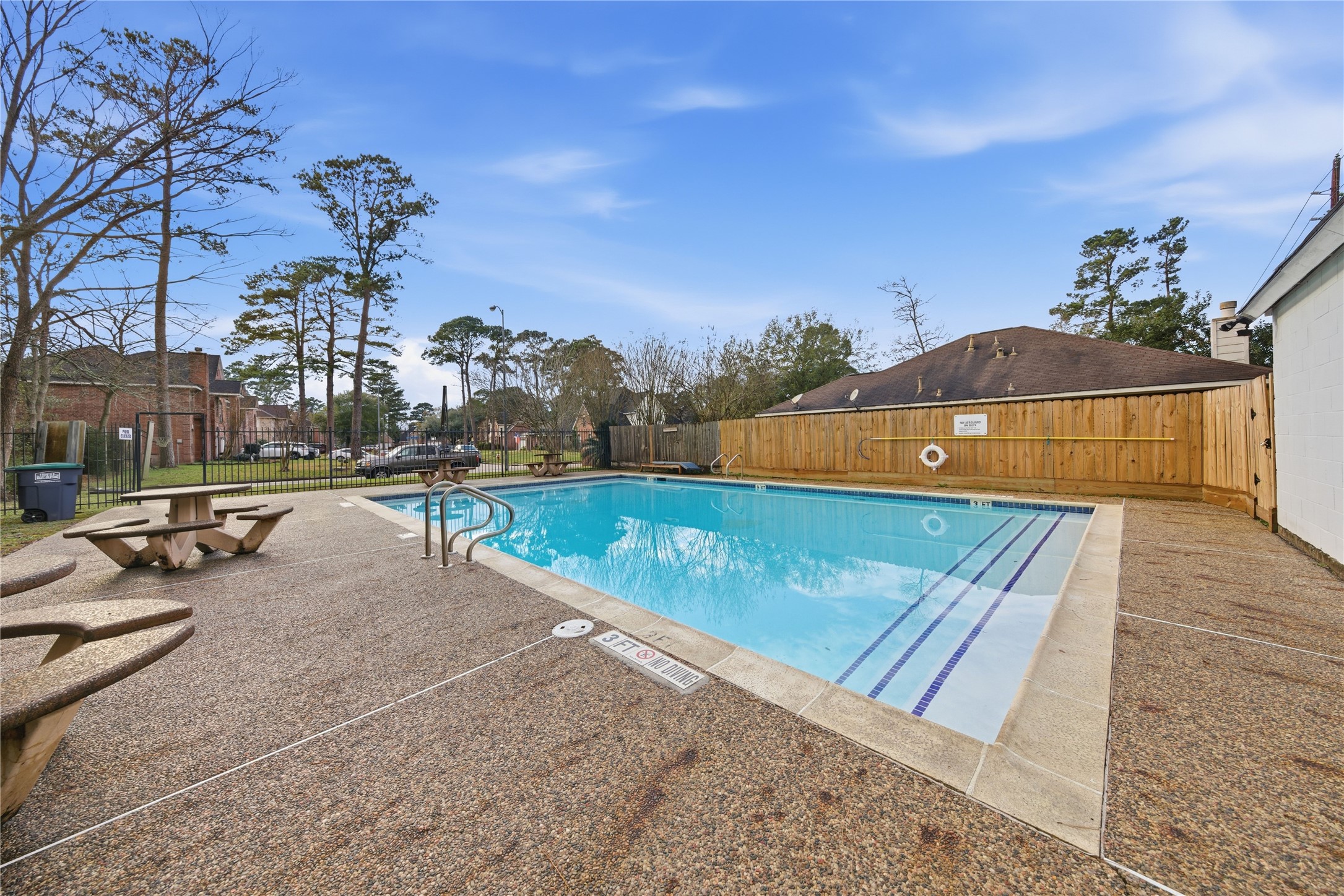 13506 Spring Court Tomball, TX 77375 - Photo 37 of 37 a view of a swimming pool with a bench and trees in the background