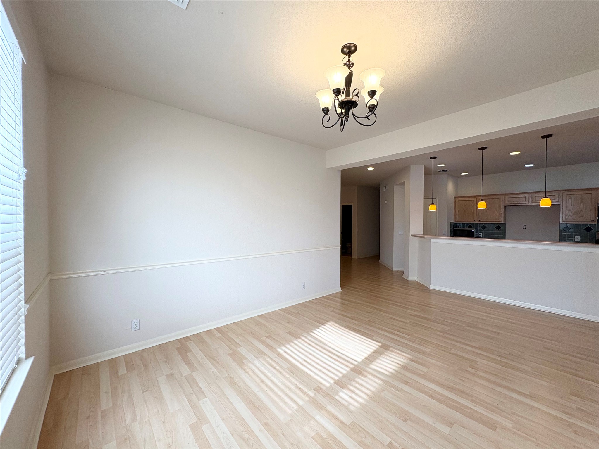 7006 Rambollet Terrace Round Rock, TX 78681 - Photo 9 of 38 Natural light bathes this spacious dining area with elegant flooring and a direct kitchen view.