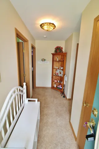 a view of an empty room with stairs and a door