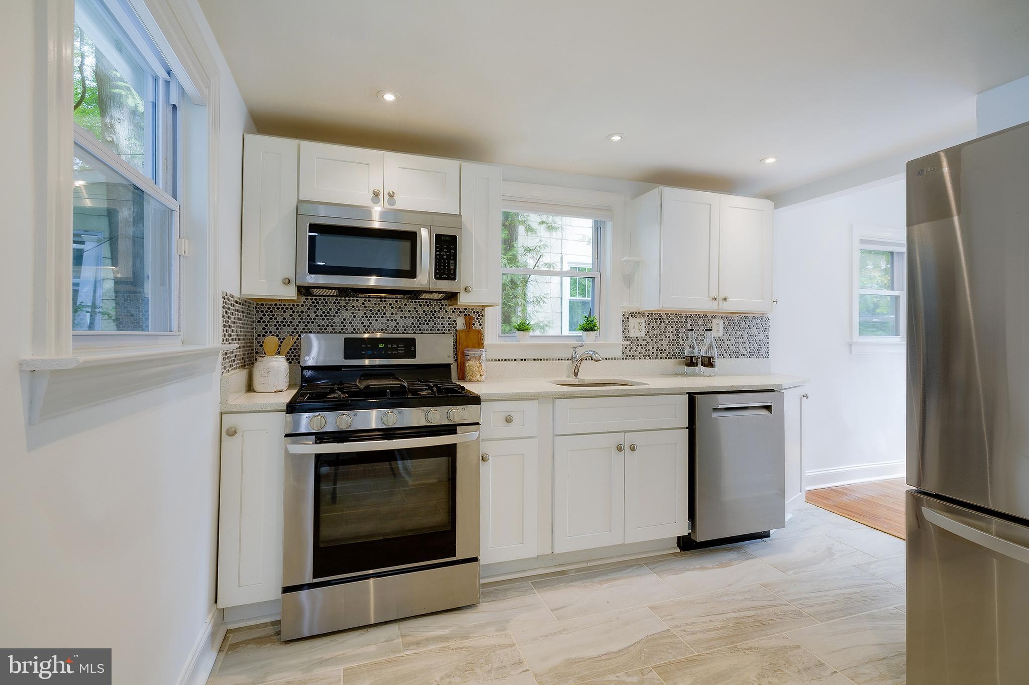 704 Maplewood Avenue Takoma Park, MD 20912 - Photo 15 of 54 a kitchen with a stove top oven and sink