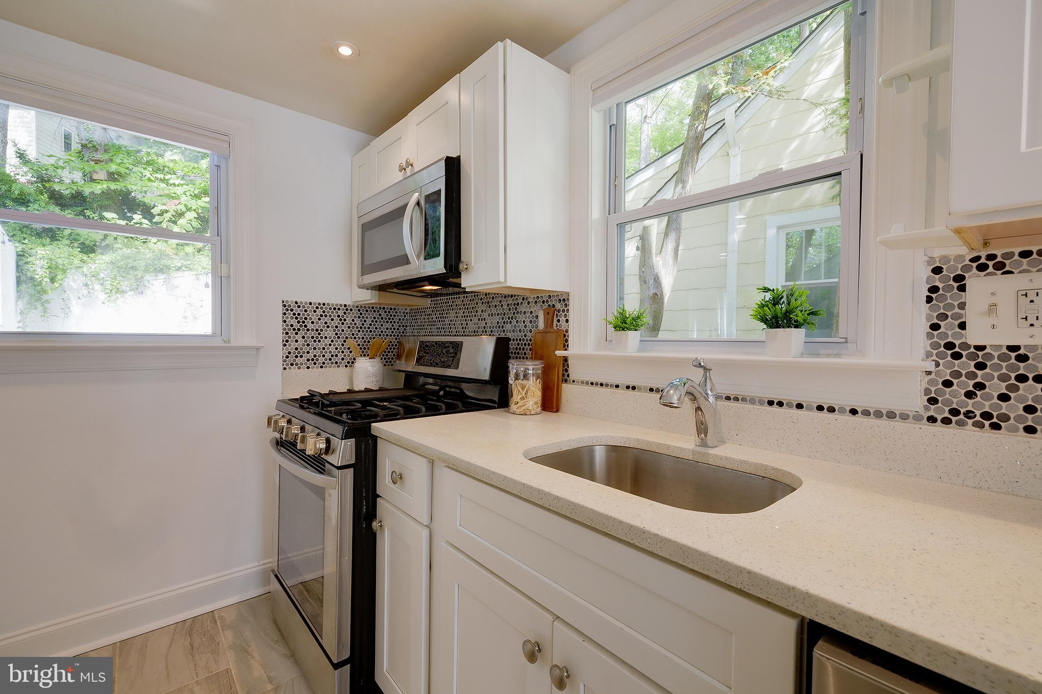 704 Maplewood Avenue Takoma Park, MD 20912 - Photo 17 of 54 a kitchen with a stove and a sink