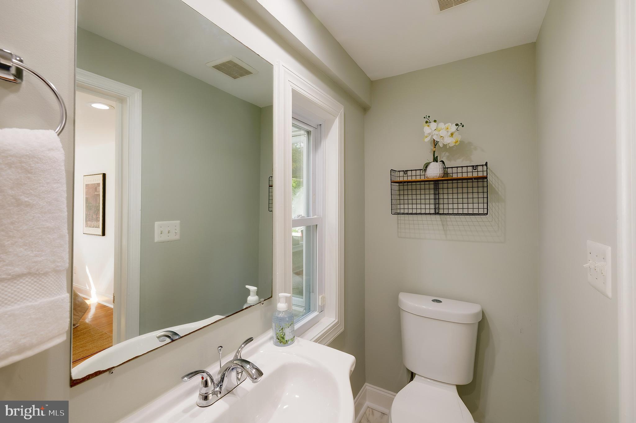 704 Maplewood Avenue Takoma Park, MD 20912 - Photo 27 of 54 a bathroom with a toilet sink and mirror