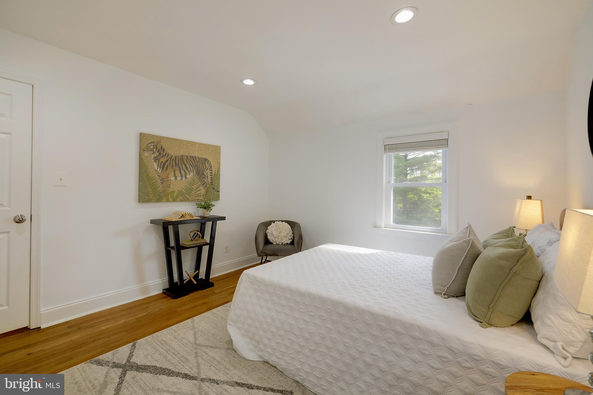 704 Maplewood Avenue Takoma Park, MD 20912 - Photo 30 of 54 a bedroom with a bed and a table with chair