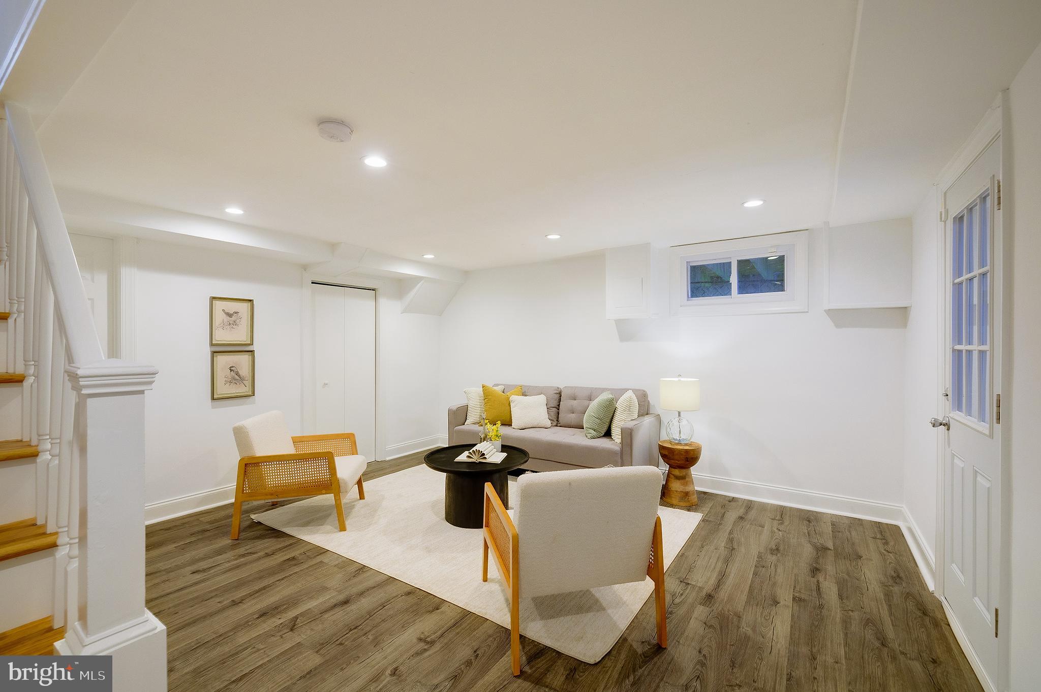 704 Maplewood Avenue Takoma Park, MD 20912 - Photo 36 of 54 a living room with furniture and a wooden floor