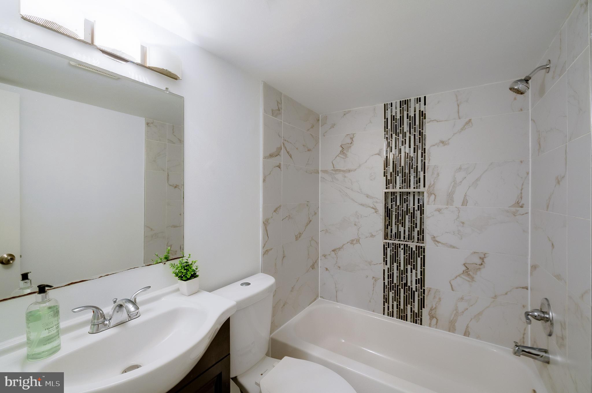 704 Maplewood Avenue Takoma Park, MD 20912 - Photo 40 of 54 a bathroom with a sink toilet and shower