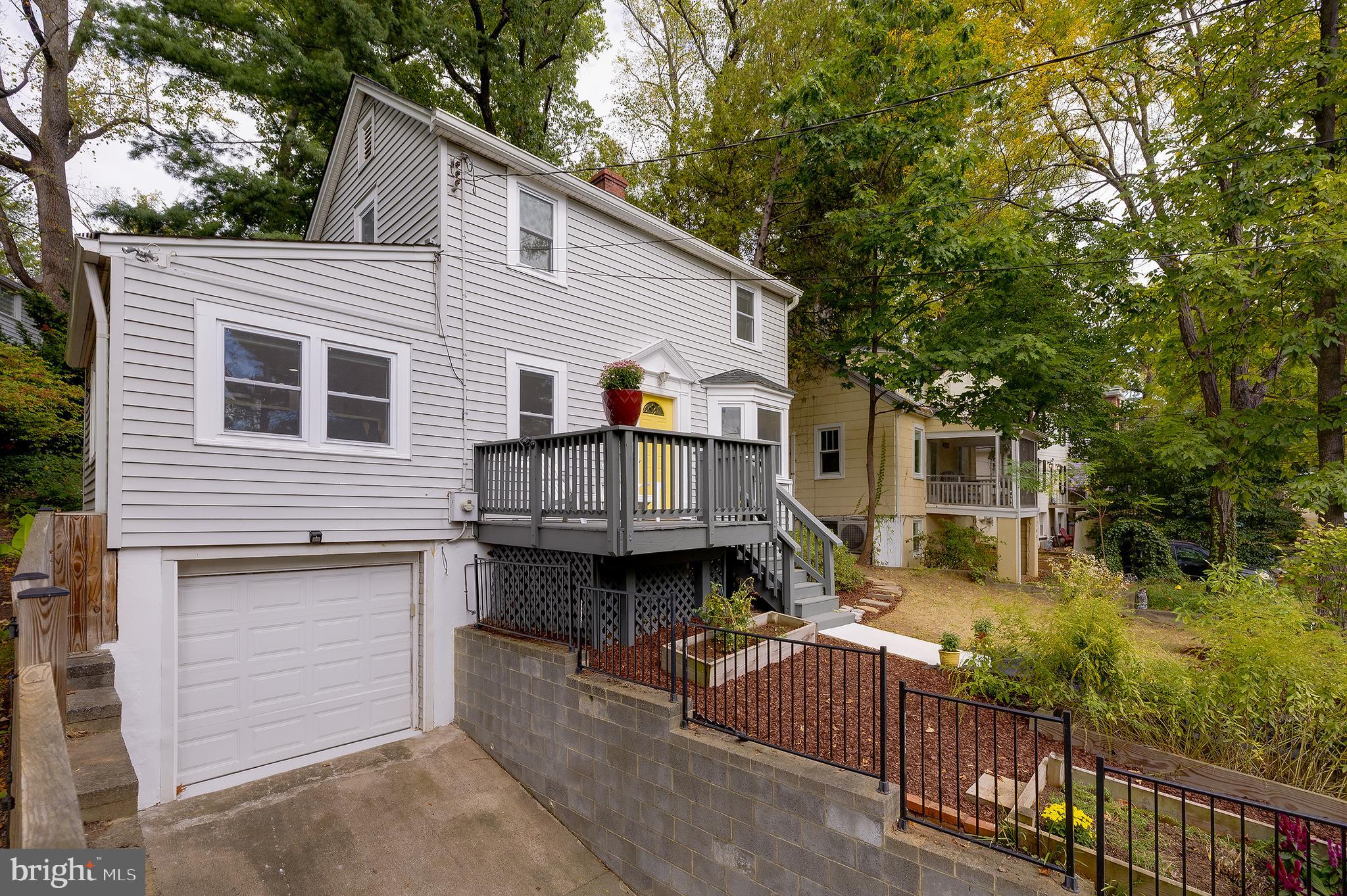 704 Maplewood Avenue Takoma Park, MD 20912 - Photo 50 of 54 a front view of house with yard and trees in the background