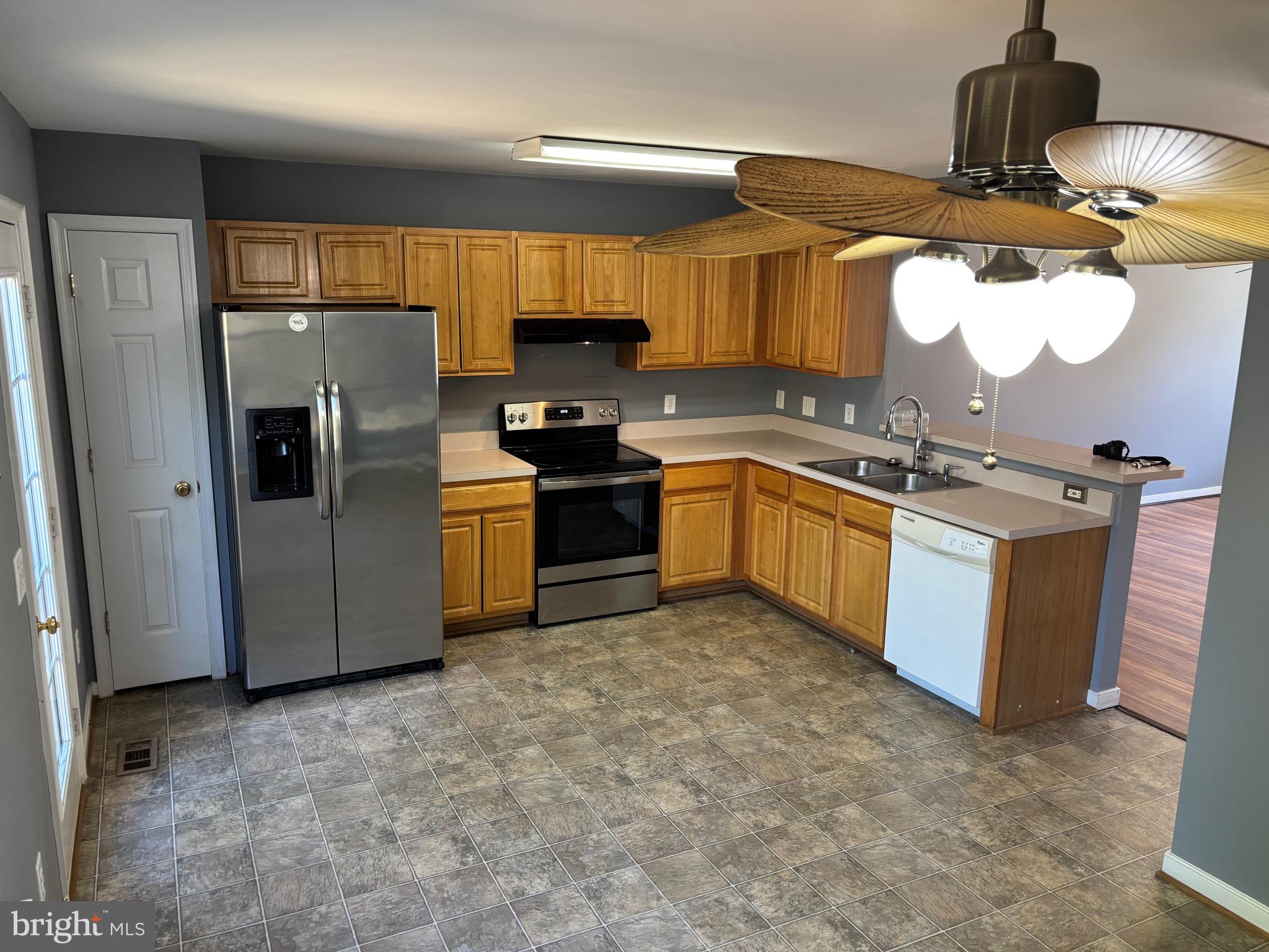 200 Torbert Loop Stafford, VA 22554 - Photo 11 of 28 a kitchen with stainless steel appliances granite countertop a sink a stove and a refrigerator