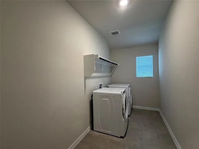a view of kitchen with stainless steel appliances a refrigerator and a stove top oven