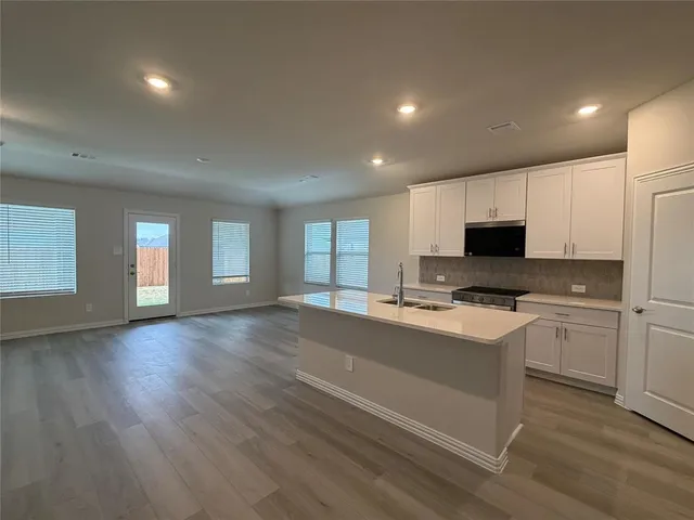 a kitchen with a stove a sink and a refrigerator
