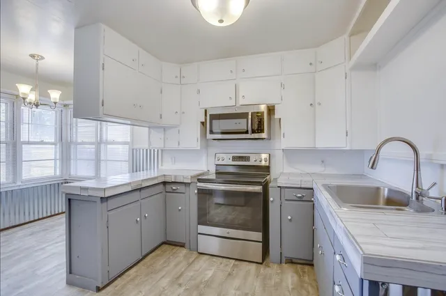 a kitchen with a sink stove and microwave