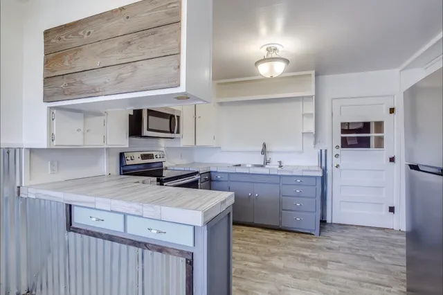a kitchen with granite countertop a sink and cabinets
