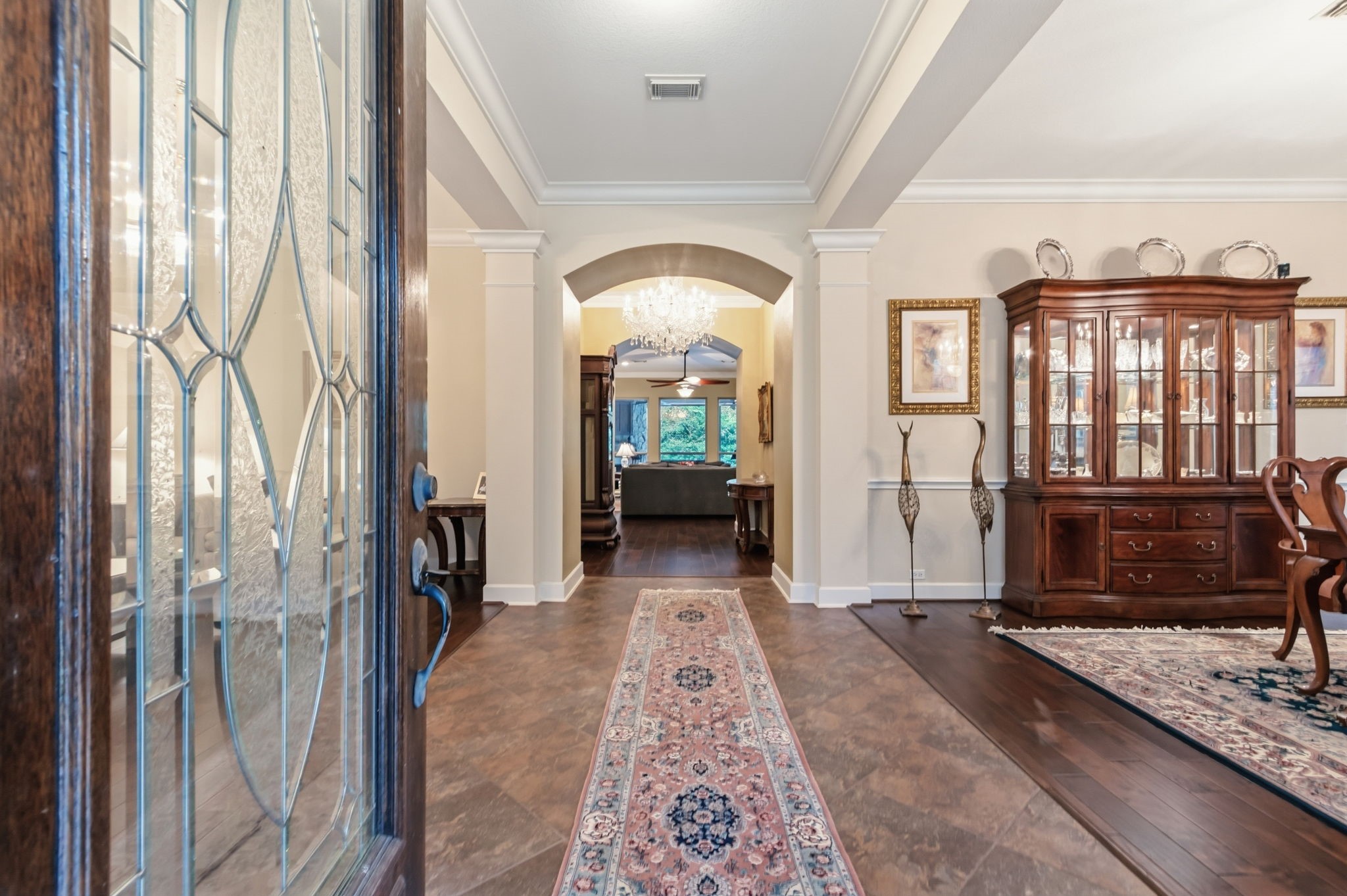 7514 Saddle Blanket Drive Waller, TX 77484 - Photo 6 of 50 This elegant living space features hardwood flooring, tiled entryway with an arched passage. The lovely crown molding adds to the beauty of this house. The chandelier is excluded from the sale.
