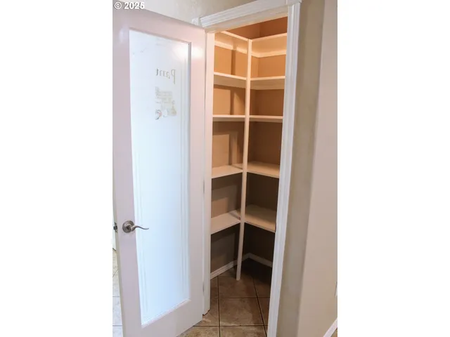 a view of closet with white walls