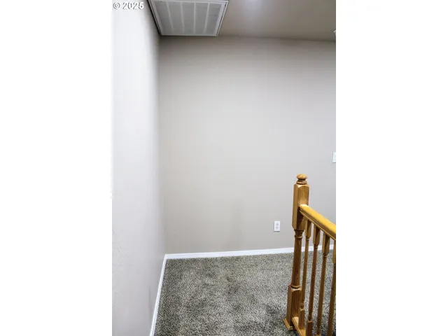 a view of a room with wall mirror