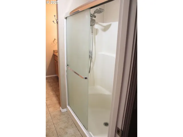 a bathroom with a glass shower door