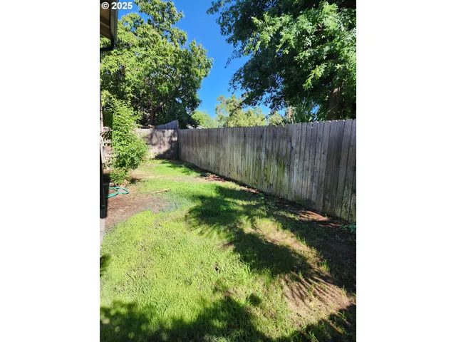 a backyard of a house with lots of green space