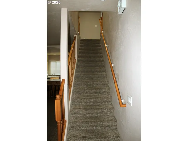 a view of a hallway with stairs