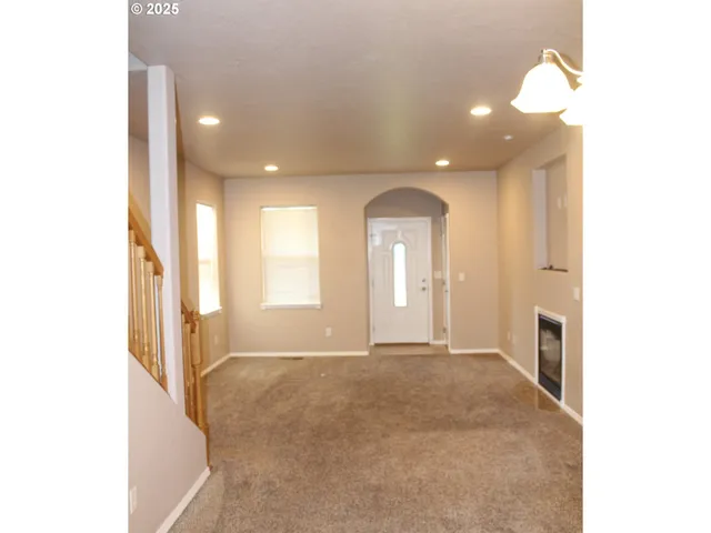 a view of an empty room with a fireplace