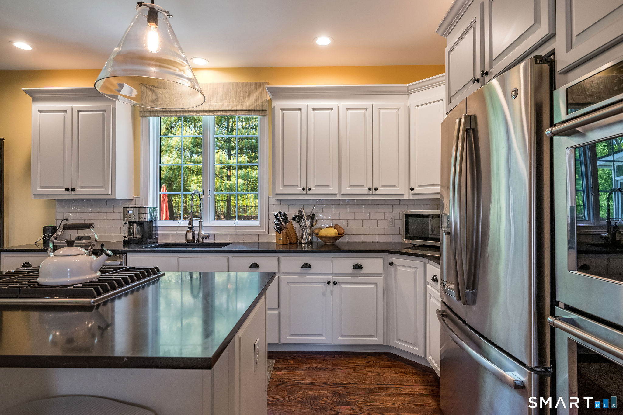 170 Devonshire Lane Madison, CT 06443 - Photo 7 of 39 a kitchen with kitchen island granite countertop a sink cabinets stainless steel appliances and a window