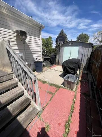 a view of a patio with table and chairs and potted plants