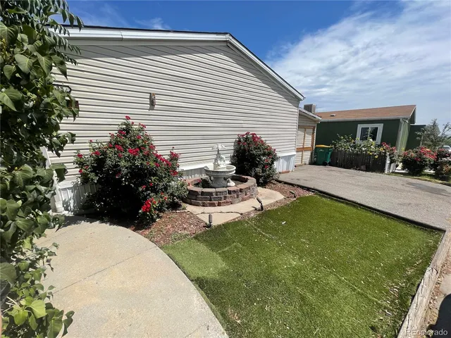 a view of a backyard with plants and patio