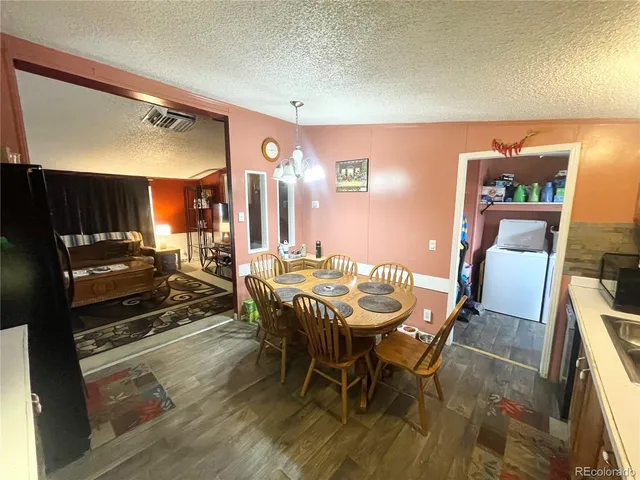 a dining room with furniture and wooden floor
