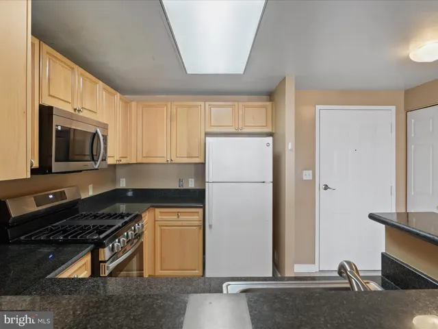 a kitchen with a refrigerator stove and microwave