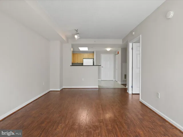 a view of a livingroom with wooden floor and a window