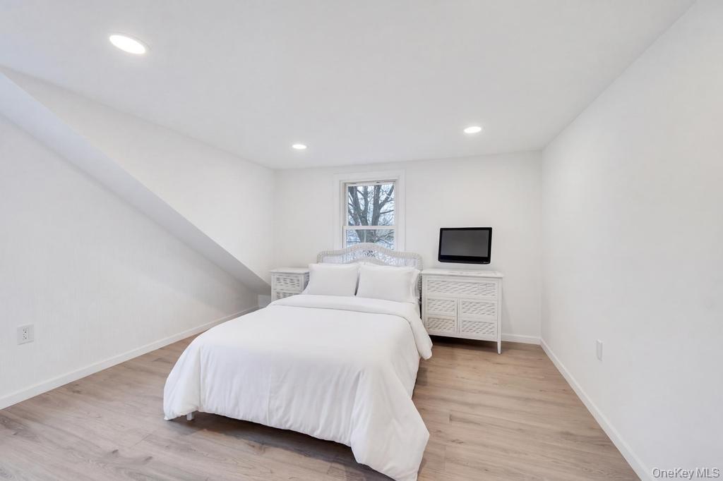 3 Adams Road Central Islip, NY 11722 - Photo 13 of 22 a bedroom with a bed and a flat screen tv