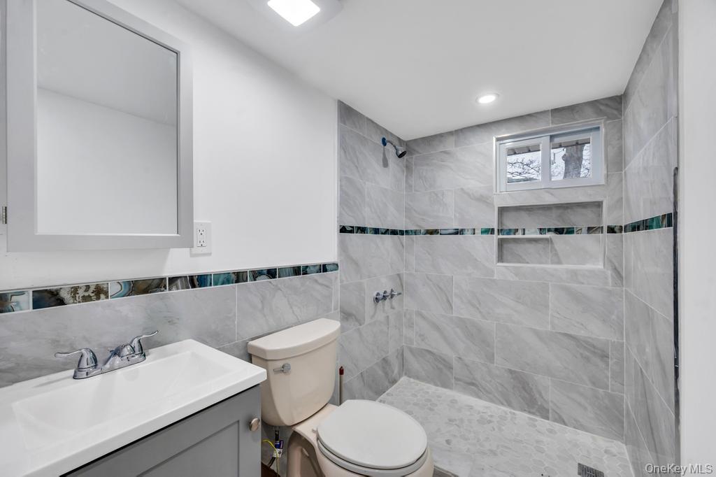 3 Adams Road Central Islip, NY 11722 - Photo 14 of 22 a bathroom with a sink toilet and shower