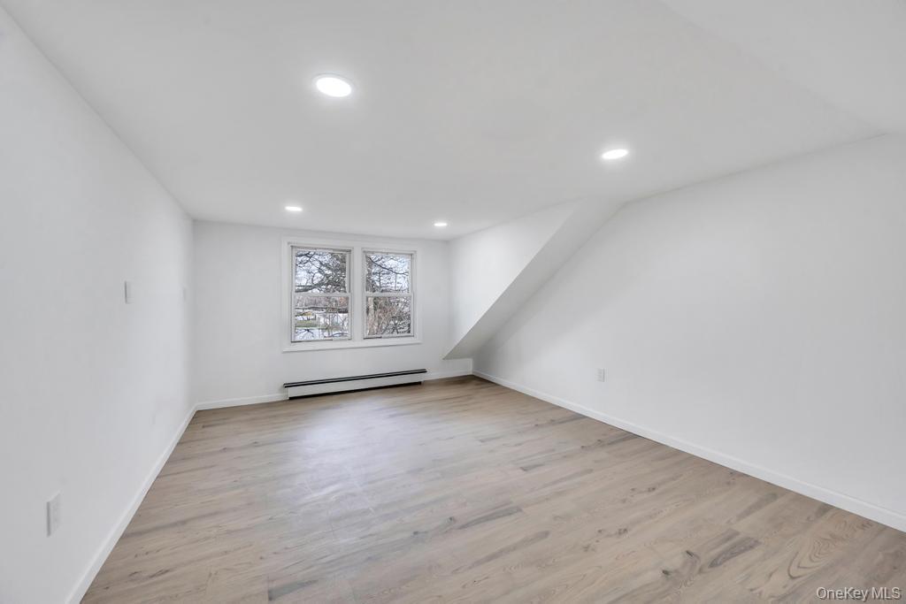 3 Adams Road Central Islip, NY 11722 - Photo 16 of 22 wooden floor in an empty room with a window