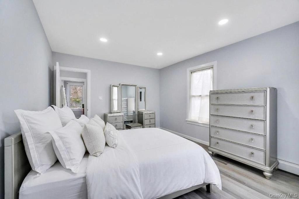3 Adams Road Central Islip, NY 11722 - Photo 9 of 22 a bedroom with a bed and a dresser