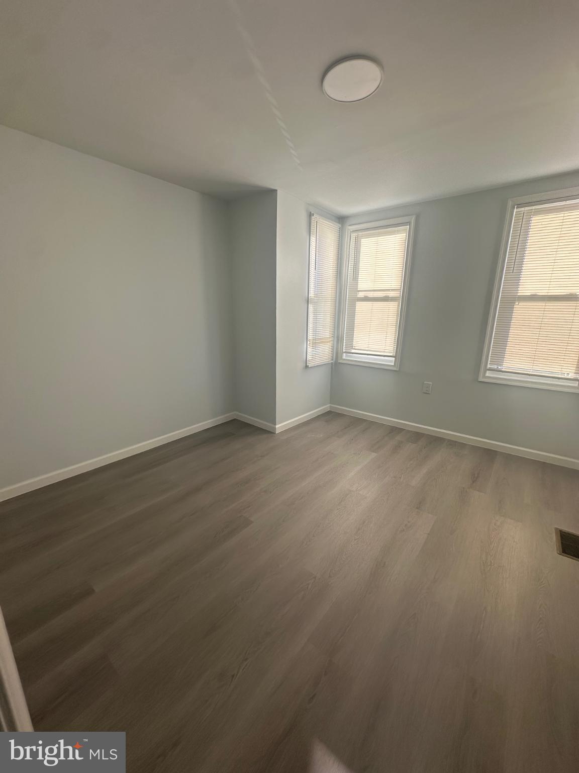 5100 Cottage Street Philadelphia, PA 19124 - Photo 15 of 20 an empty room with wooden floor and windows