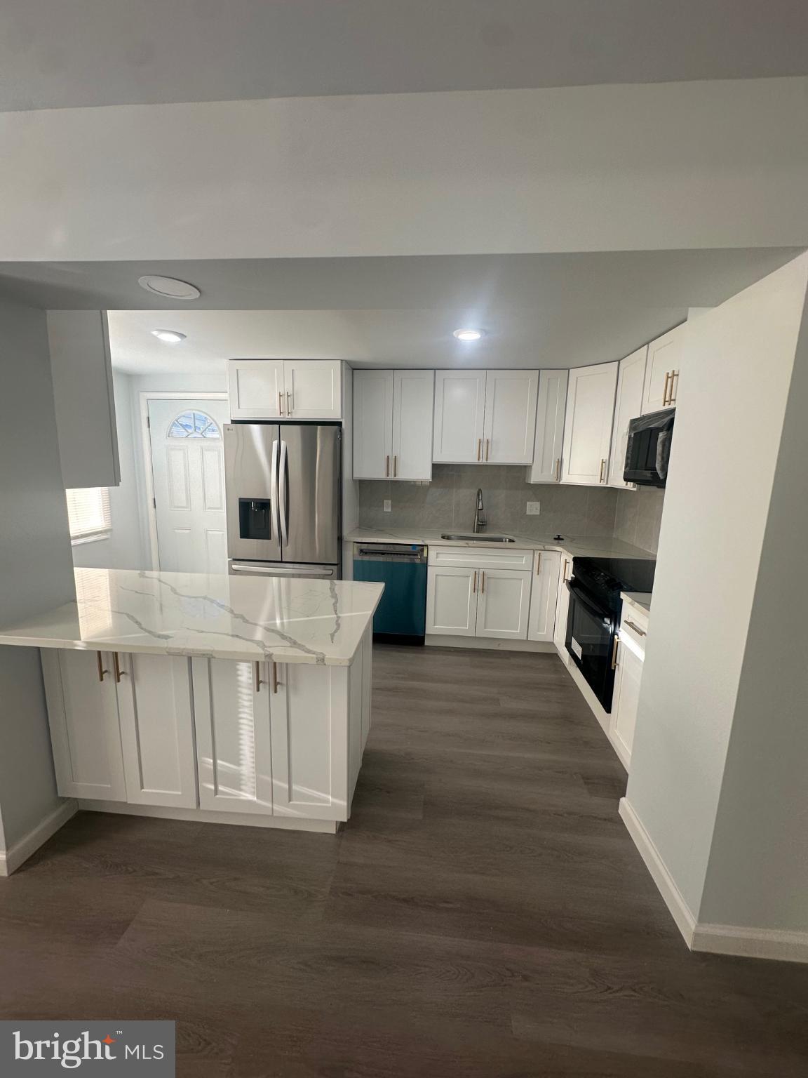 5100 Cottage Street Philadelphia, PA 19124 - Photo 7 of 20 a large kitchen with cabinets and wooden floor