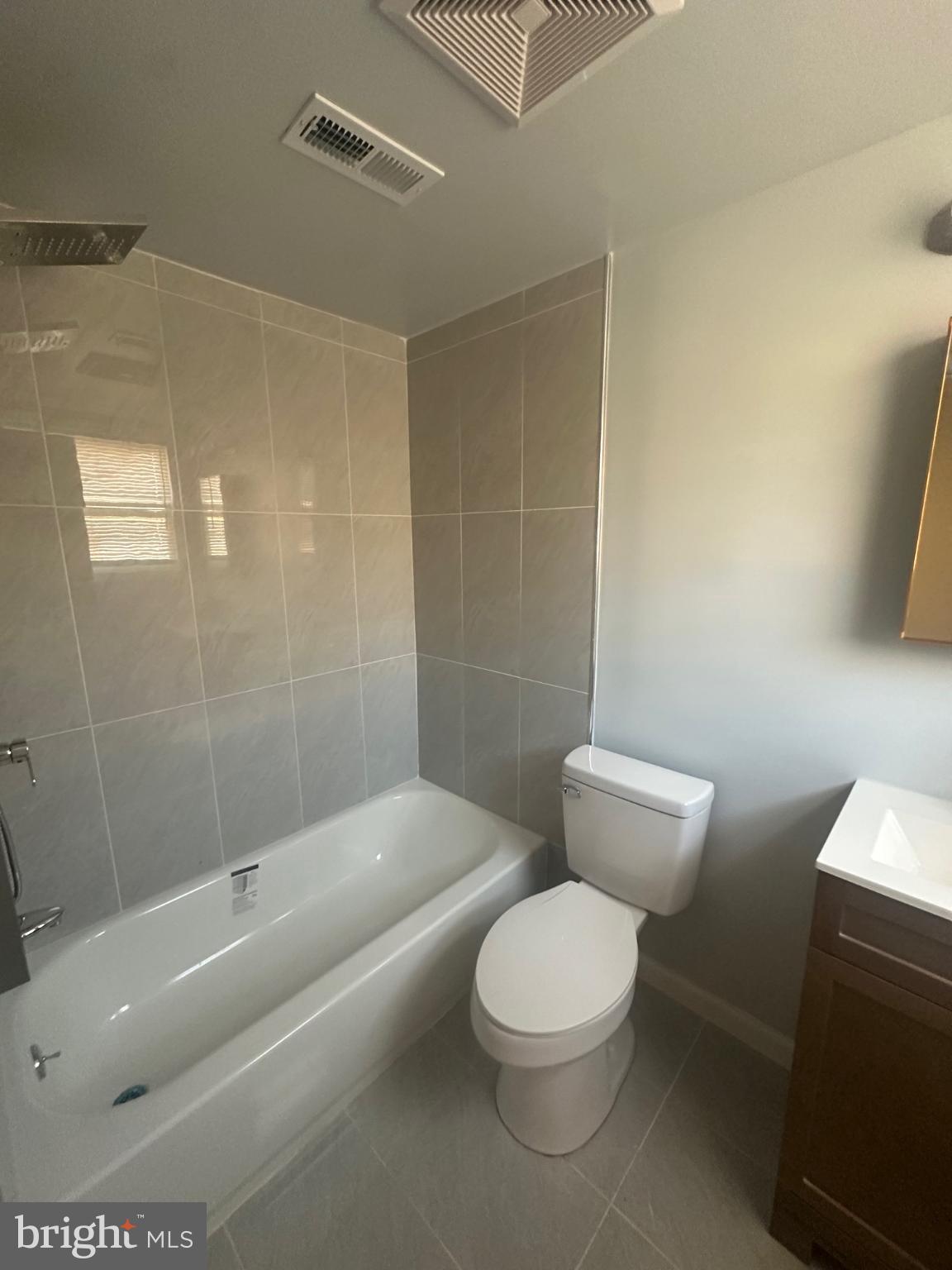 5100 Cottage Street Philadelphia, PA 19124 - Photo 9 of 20 a white toilet and tub sitting next to a bathroom sink