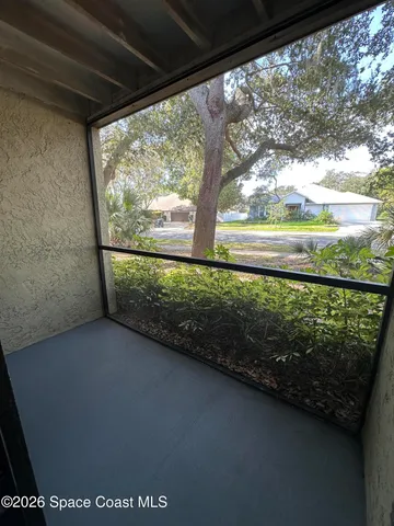 a view of a back yard from a balcony
