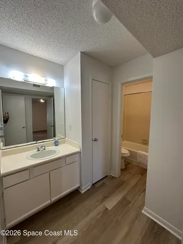 a view of a bathroom with a sink mirror and a toilet