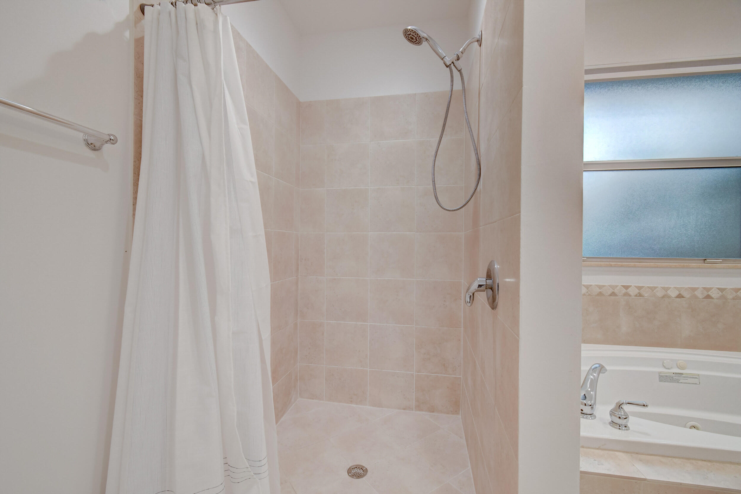 21 Oceanview Drive, Unit C Ocean Ridge, FL 33435 - Photo 15 of 17 a bathroom with a glass shower door