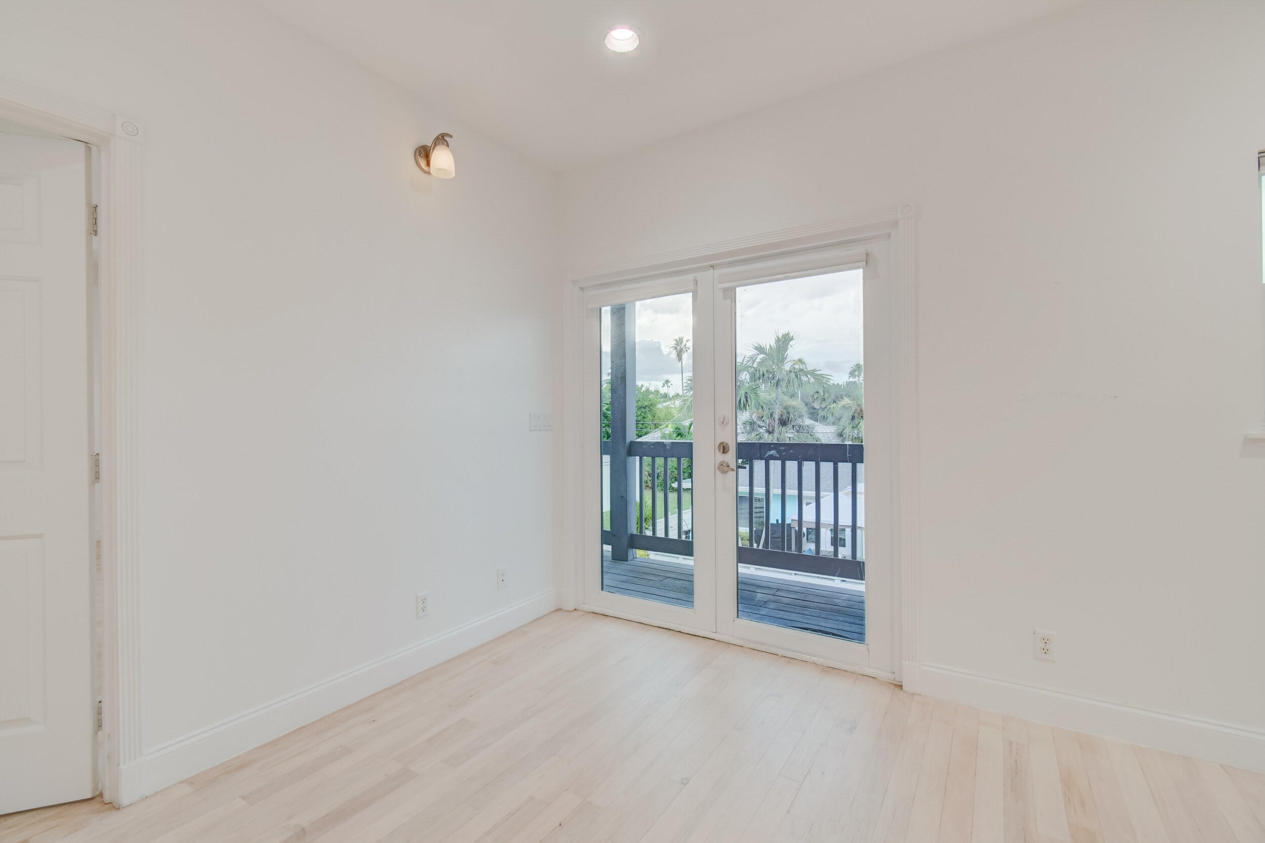 21 Oceanview Drive, Unit C Ocean Ridge, FL 33435 - Photo 5 of 17 an empty room with wooden floor and sliding door