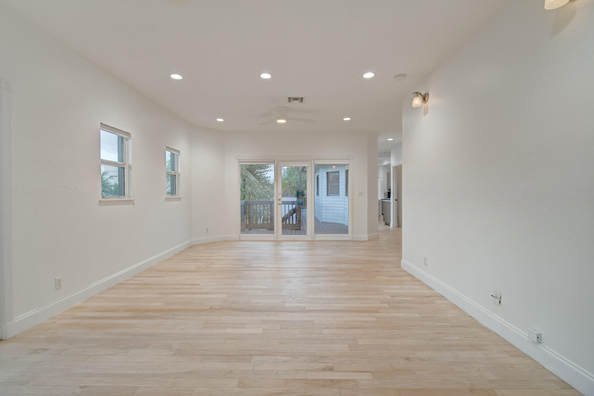 21 Oceanview Drive, Unit C Ocean Ridge, FL 33435 - Photo 7 of 17 a view of an empty room with wooden floor and a window