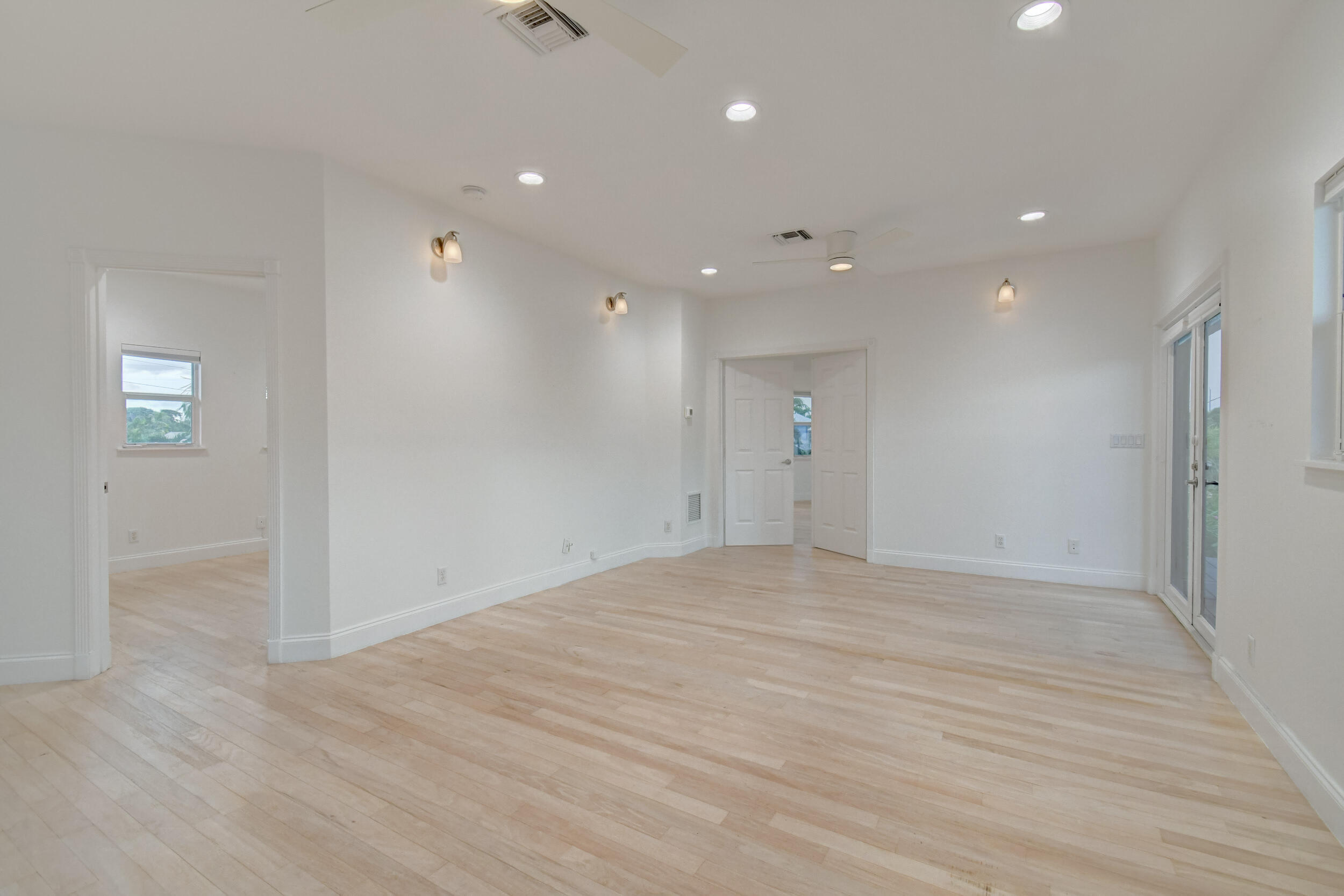 21 Oceanview Drive, Unit C Ocean Ridge, FL 33435 - Photo 8 of 17 a view of an empty room with wooden floor and a window