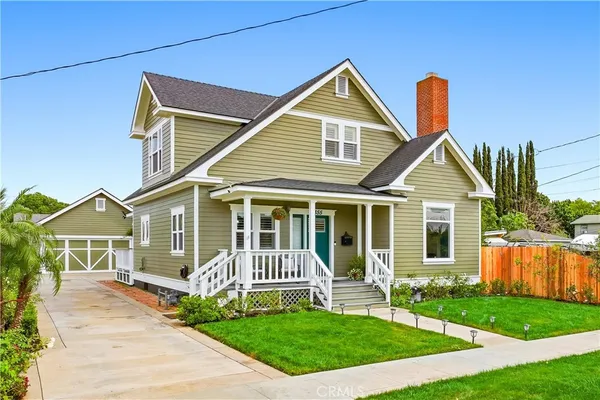 a view of a house with a yard and deck