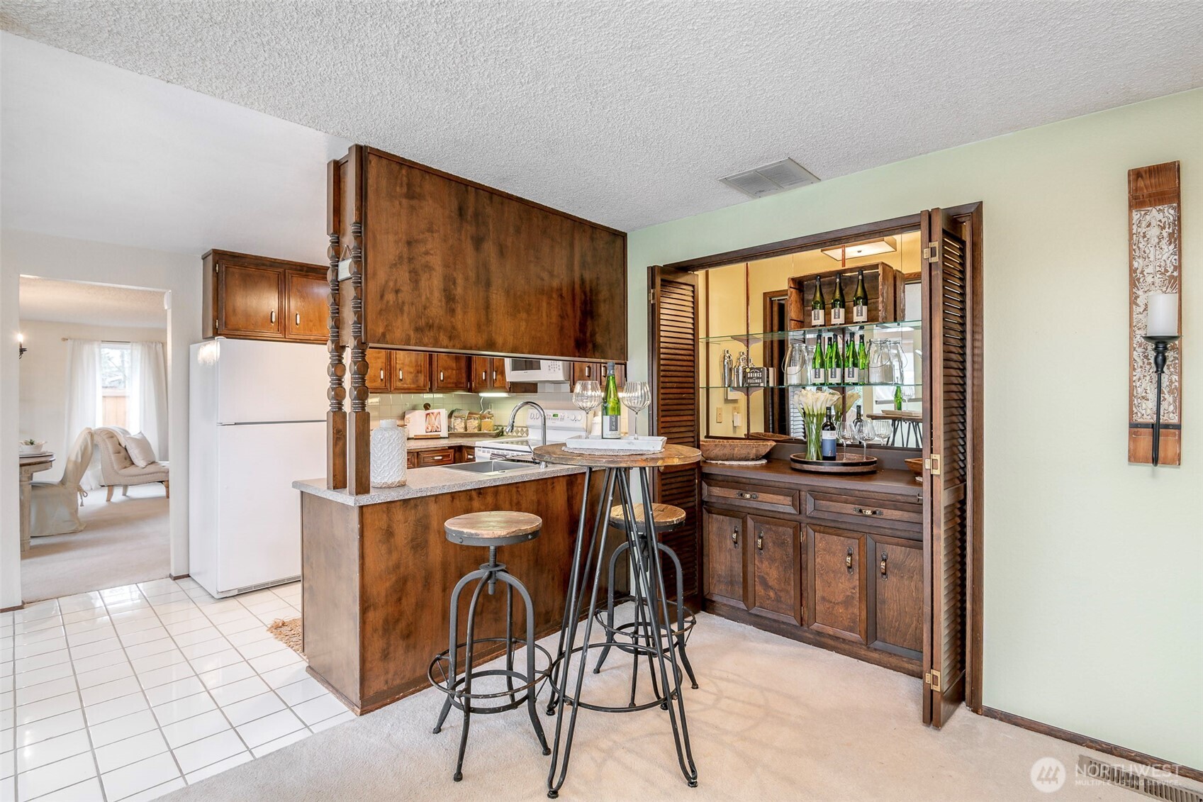 61 Bonney Street Steilacoom, WA 98388 - Photo 13 of 34 a kitchen with a table chairs refrigerator and cabinets