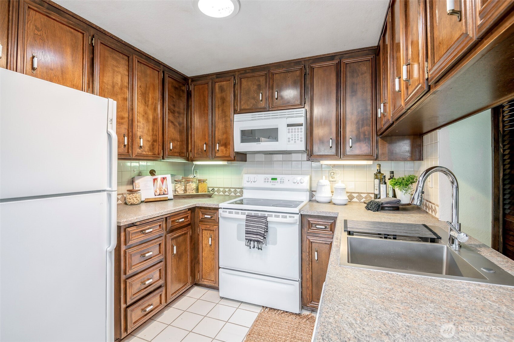 61 Bonney Street Steilacoom, WA 98388 - Photo 14 of 34 a kitchen with a sink a stove and refrigerator