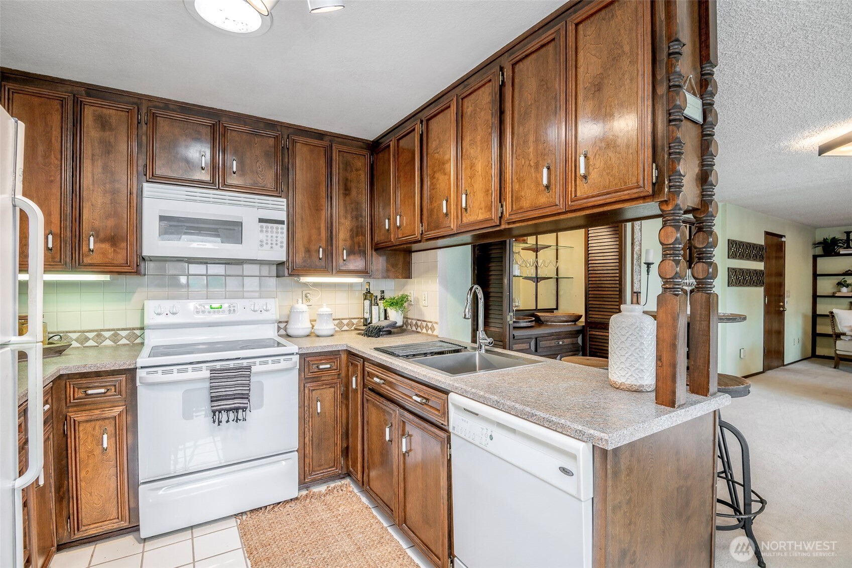 61 Bonney Street Steilacoom, WA 98388 - Photo 15 of 34 a kitchen with stainless steel appliances granite countertop a sink stove and refrigerator