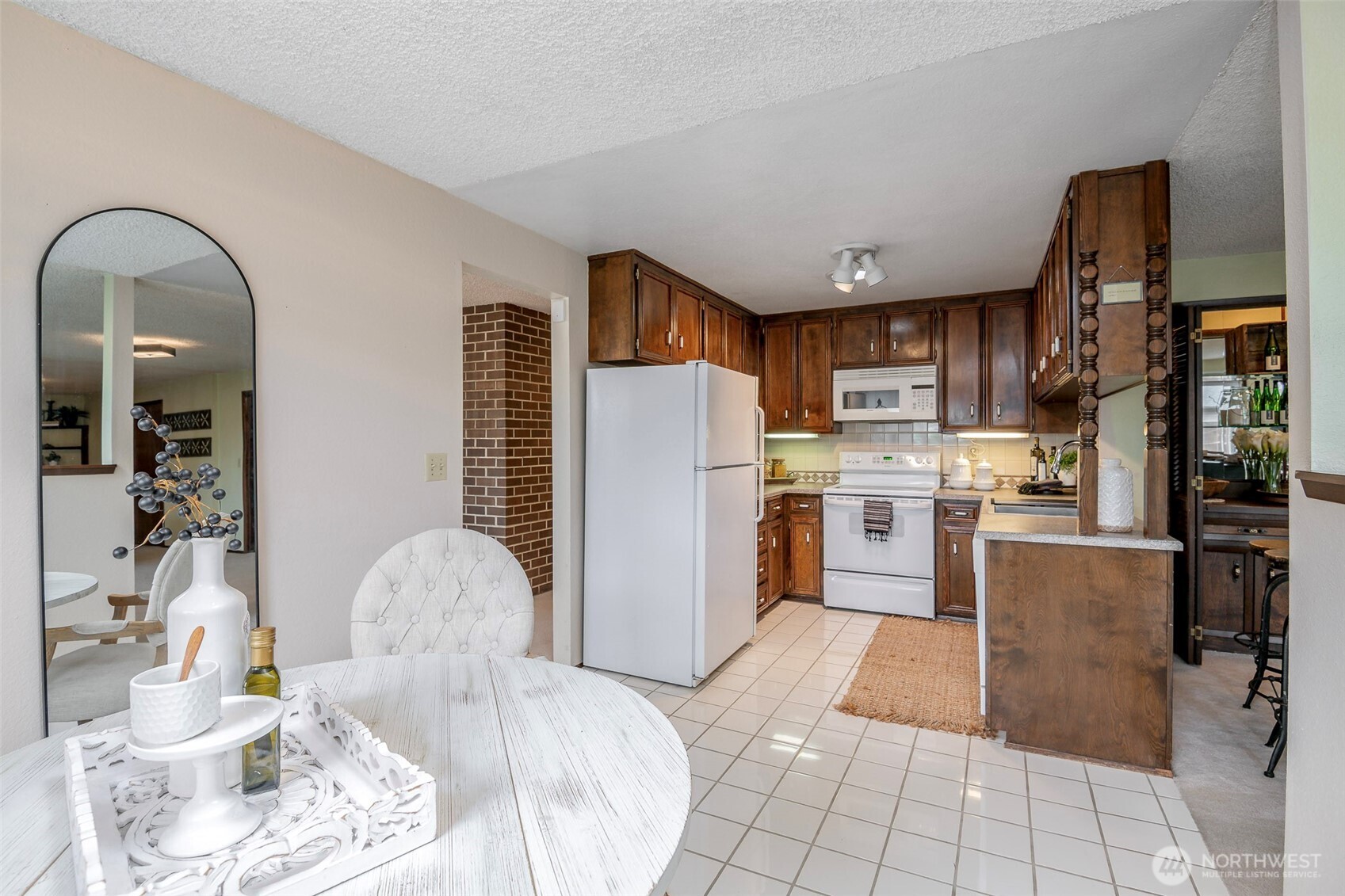 61 Bonney Street Steilacoom, WA 98388 - Photo 16 of 34 a kitchen with stainless steel appliances granite countertop a refrigerator a stove and a sink with granite countertops