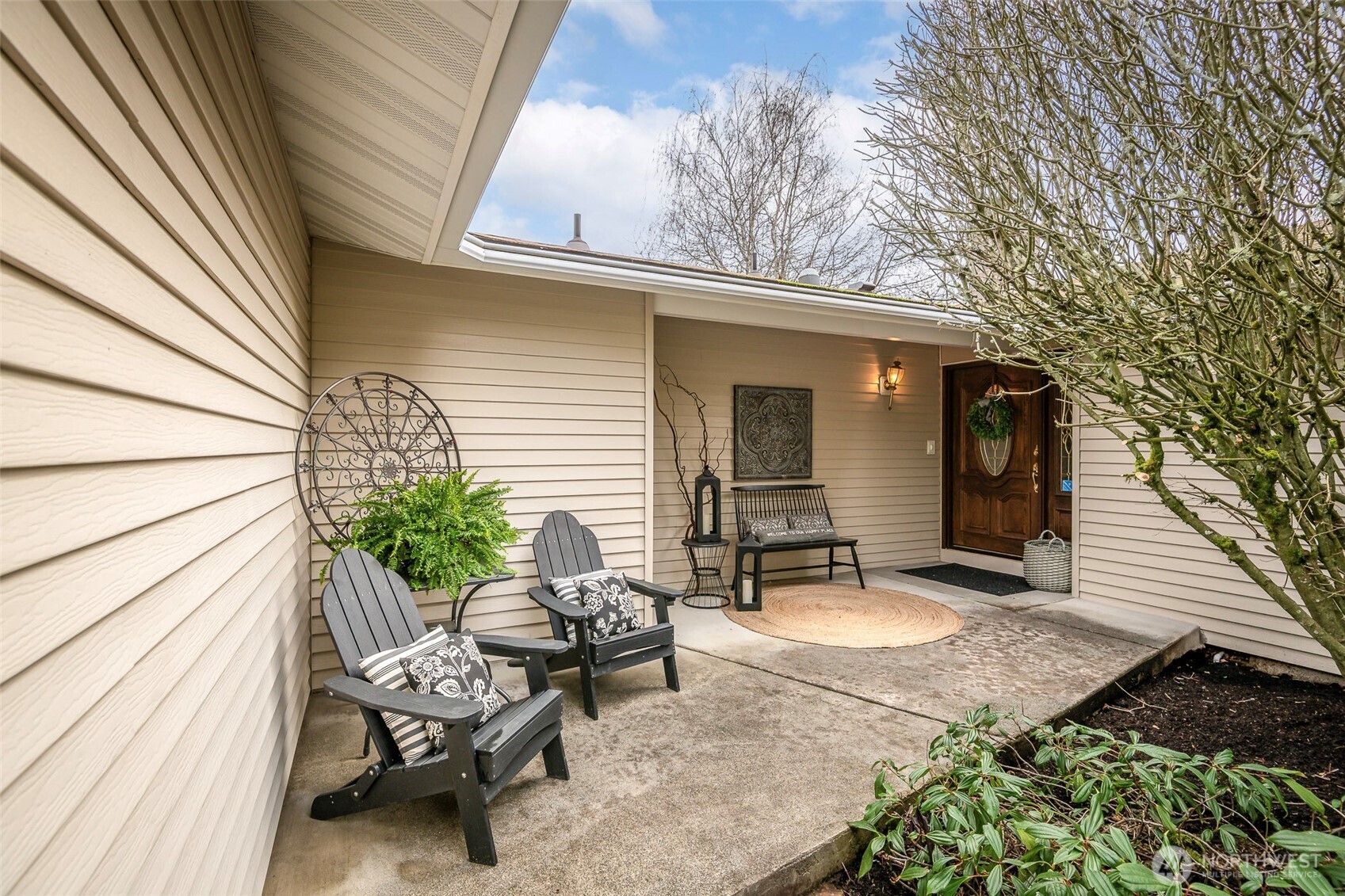 61 Bonney Street Steilacoom, WA 98388 - Photo 2 of 34 a view of a patio with table and chairs and wooden floor