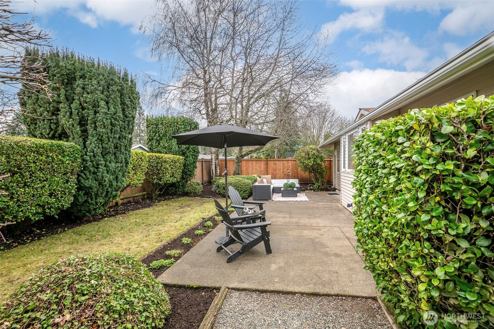 61 Bonney Street Steilacoom, WA 98388 - Photo 30 of 34 a view of a chair and table in the patio with potted plants