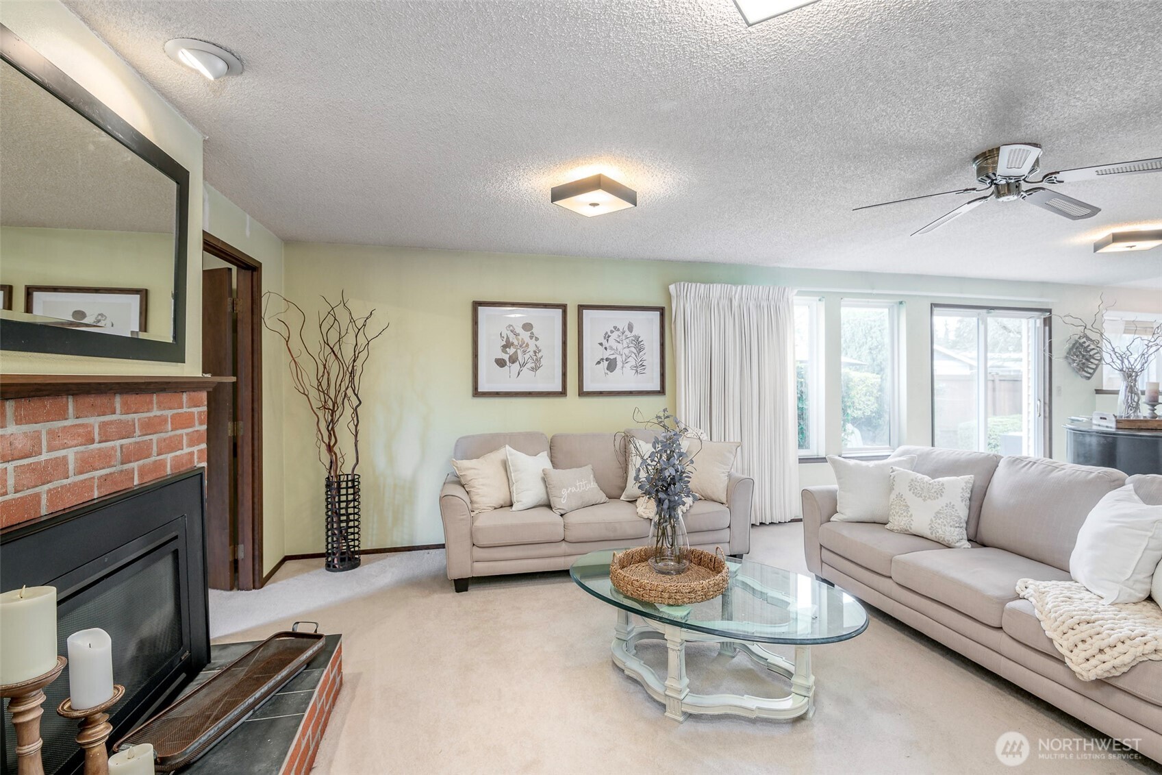 61 Bonney Street Steilacoom, WA 98388 - Photo 9 of 34 a living room with furniture a rug and a fireplace